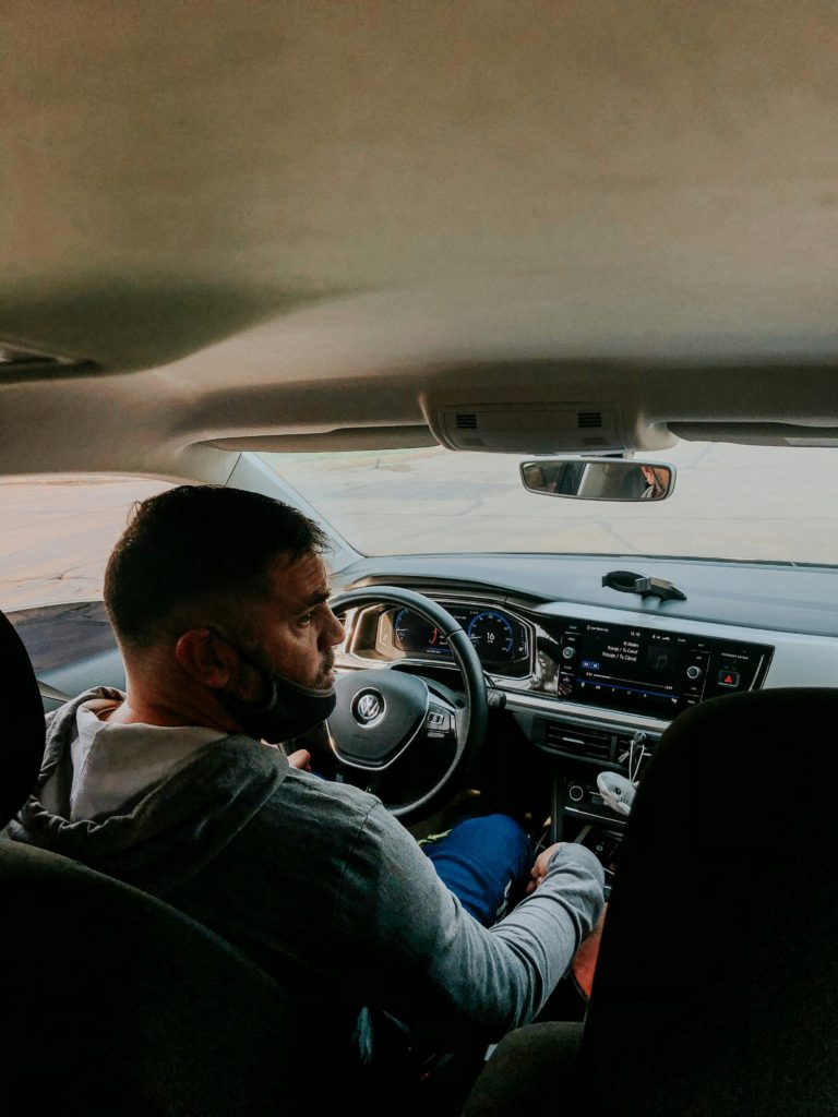 photo taken from back seat of a car of the driver